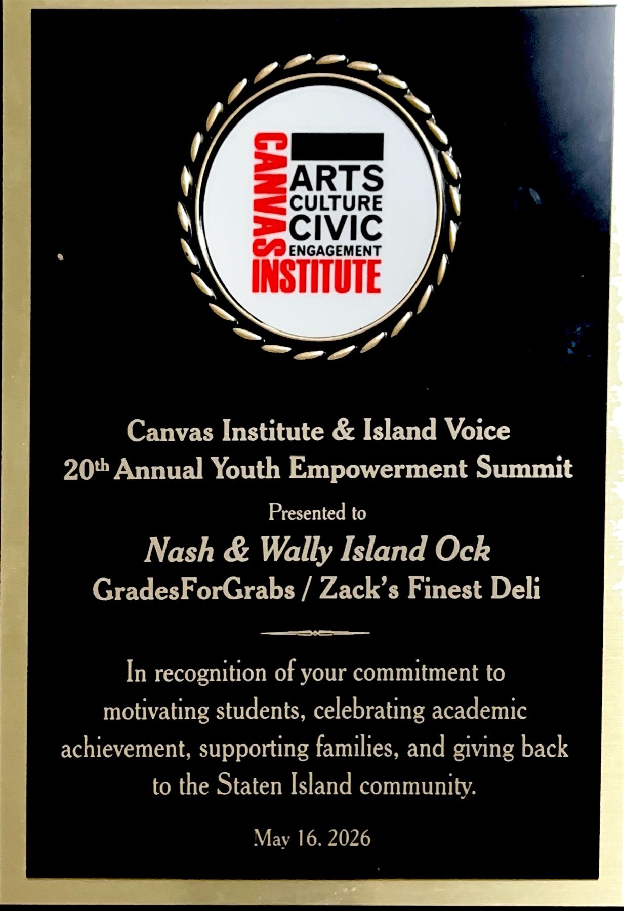Photograph of the Youth Empowerment Summit recognition plaque presented to Nash and Wally Island Ock, GradesForGrabs, and Zack’s Finest Deli.