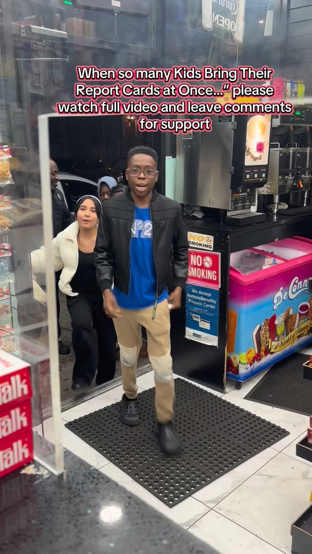 A student entering a neighborhood deli with other visitors behind them.