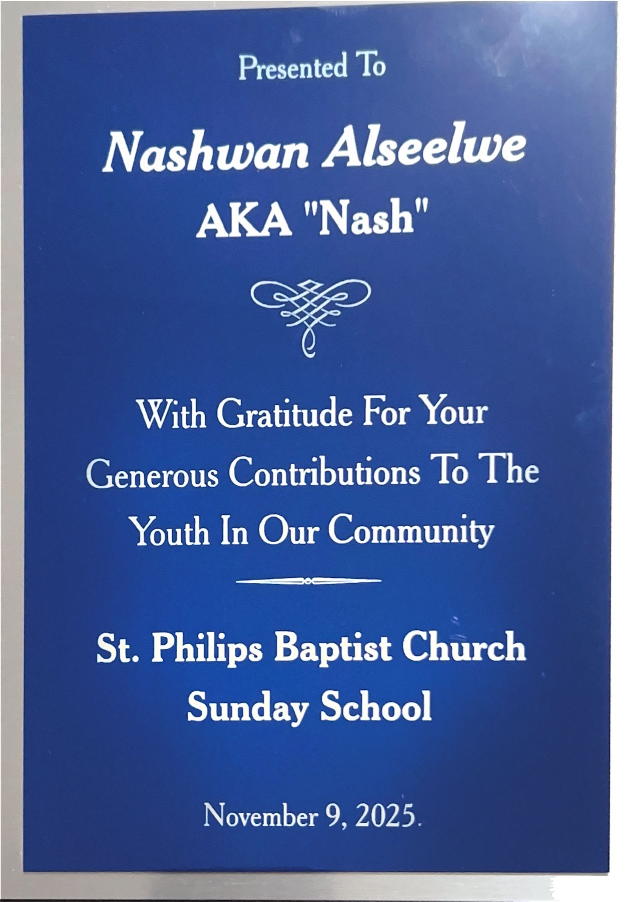 Photograph of the St. Philips Baptist Church Sunday School recognition plaque presented to Nash.